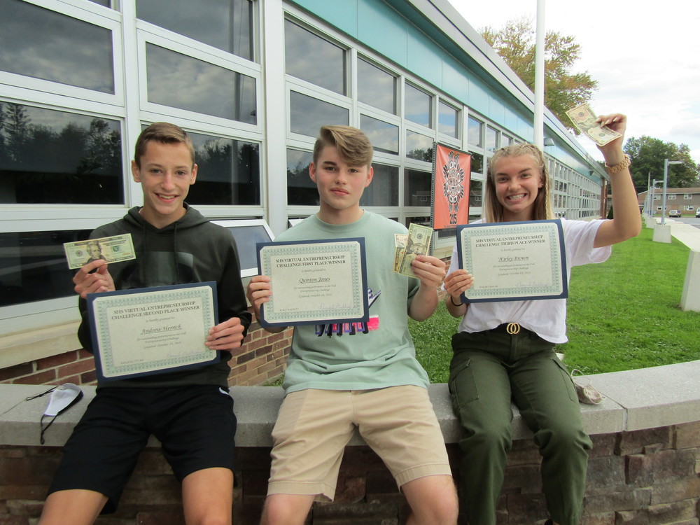 Three student winners holding certificates